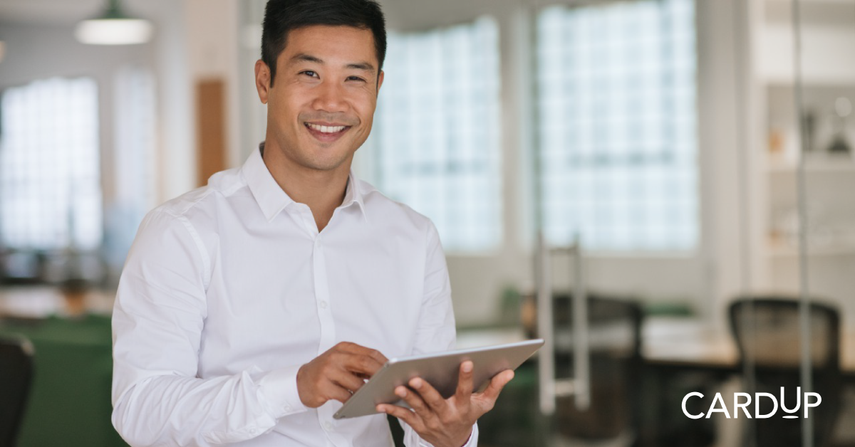 Businessman enjoys navigating CardUp platform via his ipad in office